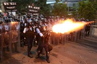 Police officers in Hong Kong fire a tear gas June 12, 2019, during a demonstration against a proposed Chinese extradition bill. The Diocese of Hong Kong issued a statement June 11 urging the city&#039;s government &quot;not to rush to amend&quot; its controversial extradition treaty.