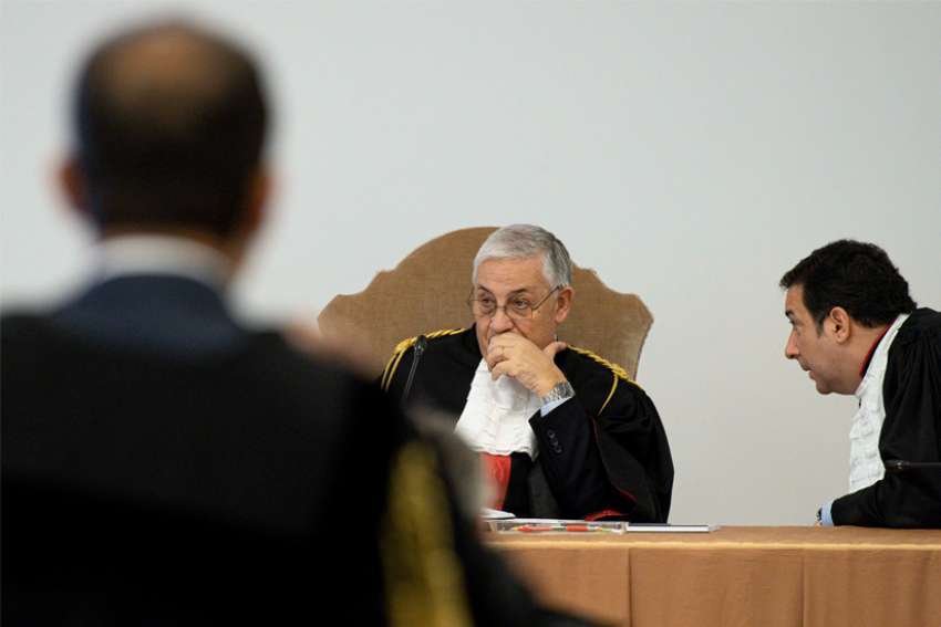 Judges Giuseppe Pignatone and Carlo Bonzano preside at the third session of the trial of six defendants accused of financial crimes, including Cardinal Angelo Becciu, at the Vatican City State criminal court Nov. 17, 2021. Lawyers representing the defendants argued that Vatican prosecutors omitted evidence and testimony they said are crucial in preparing their defense.
