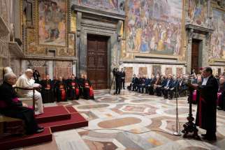 Pope Francis listens as Gian Piero Milano, promoter of justice at the Vatican City state court, speaks during the opening of the 91st judicial year of the court during an audience in the Apostolic Palace at the Vatican Feb. 15, 2020.