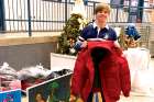 Catholic Central High School student James Bell from the London, Ont., school’s Crusaders in Action club with coats donated for the needy.