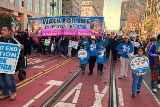 High school and college students hold the Walk for Life banner as pro-life supporters exit Civic Center Plaza to begin the mile-long trek along San Francisco&#039;s Market Street Jan. 21, 2023. 