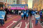 High school and college students hold the Walk for Life banner as pro-life supporters exit Civic Center Plaza to begin the mile-long trek along San Francisco&#039;s Market Street Jan. 21, 2023. 