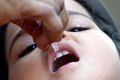 A child receives polio drops at a polio booth in the central Indian city of Bhopal in this 2008 file photo. Church workers said that, in some areas of India, it was difficult convincing mothers that administering polio drops would not make their children impotent.