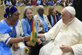 Pope Francis greets representatives of the World Union of Catholic Women’s Organizations during an audience with the group in the Paul VI hall at the Vatican May 13.