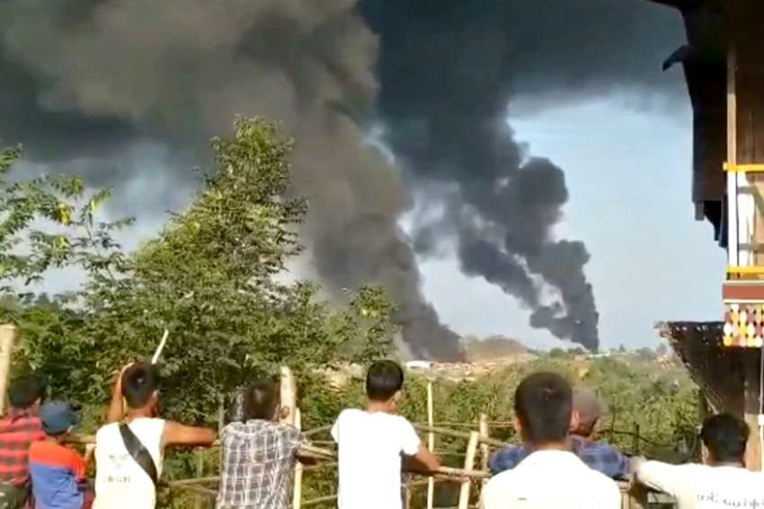 People look at thick columns of black smoke from Hkamti, Myanmar, May 22, 2021, in this picture obtained from social media. Cardinal Charles Bo of Yangon called for an end to violence after a deadly mortar attack May 23 claimed the lives of four people sheltering inside a church in a town in eastern Myanmar.