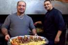 Palestinian Melkite Catholics Eli and Peter Hosh prepare meat in the kitchen of their restaurant, Abu Eli, in Bethlehem.