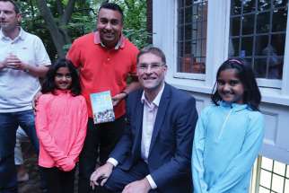 Mary’s Meals founder Magnus MacFarlance-Barrow poses with twin sisters Tianna and Audrina Alles of Oakville, who gave up their allowances this summer to the charity.