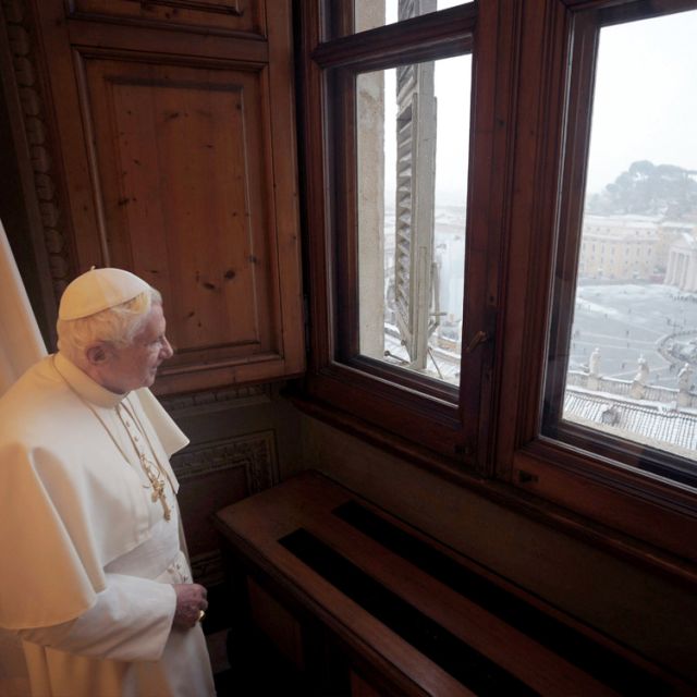 Pope Benedict XVI looks out the window overlooking St. Peter&#039;s Square at the Vatican Feb. 3 after a snowfall in Rome. A rare snowfall blanketed the Eternal City with more than 3 inches of snow.