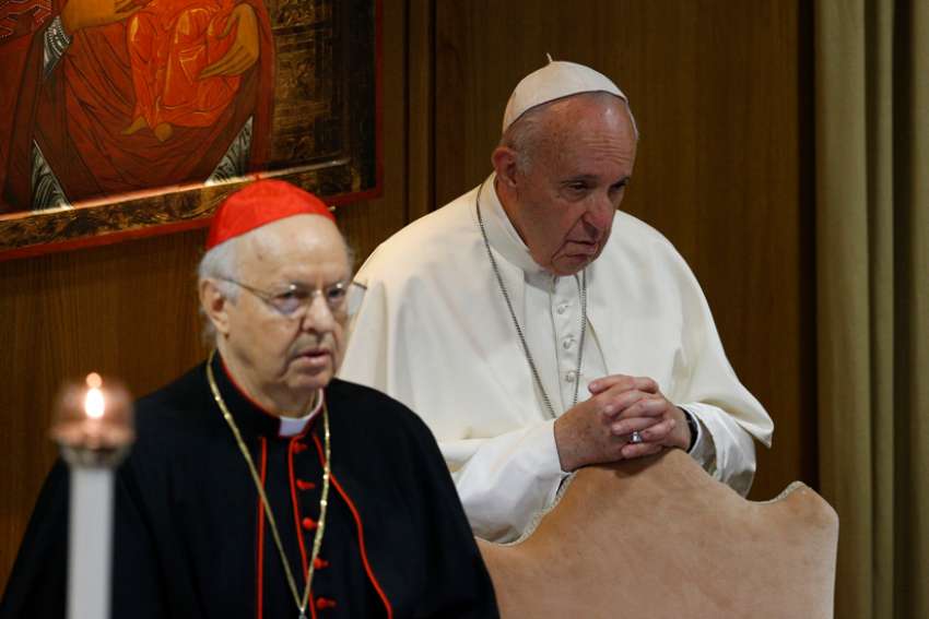 Pope Francis prays at the start of the first session of the Synod of Bishops for the Amazon at the Vatican Oct. 7, 2019. Also pictured is Cardinal Lorenzo Baldisseri, secretary-general of the Synod of Bishops.
