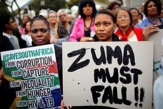 Demonstrators protest against South African President Jacob Zuma&#039;s firing of Finance Minister Pravin Gordhan outside Parliament March 31 in Cape Town. 