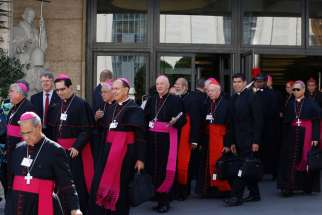 Cardinals and bishops leave the morning session of the extraordinary Synod of Bishops on the family at the Vatican Oct. 9.