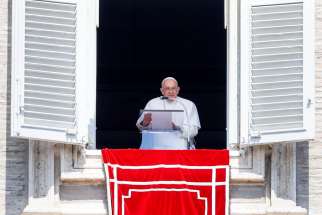 Pope Francis smiles at visitors gathered in St. Peter&#039;s Square at the Vatican after praying the Angelus Aug. 15, 2023.