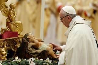  Pope Francis reverences a figurine of the baby Jesus at the start of a Mass marking the feast of the Epiphany in St. Peter&#039;s Basilica at the Vatican Jan. 6. 
