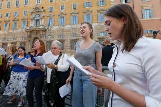 Protesters chant outside the Congregation for the Doctrine of the Faith before the opening session of the Synod of Bishops on young people, the faith and vocational discernment at the Vatican Oct 3. Protesters demanded that women be given the right to vote at the synod. 