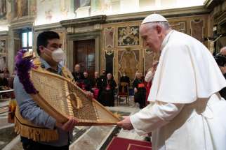 Pope Francis accepts snowshoes from Adrian Gunner, representing the Assembly of First Nations, during a meeting with Canadian Indigenous groups at the Vatican in this April 1, 2022, file photo.