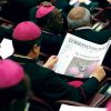 A bishop reads L’Osservatore Romano at the synod on the New Evangelization.