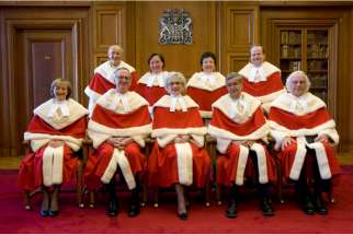 Canada&#039;s Supreme Court justices pose for a photo at the Supreme Court of Canada in Ottawa Feb. 16. From left, the justices in the front row are: Marie Deschamps, William Ian Corneil Binnie, Chief Justice Beverley McLachlin, Louis LeBel and Morris Fish. Back row: Marshall Rothstein, Rosalie Silberman Abella, Louise Charron and Thomas Cromwell.