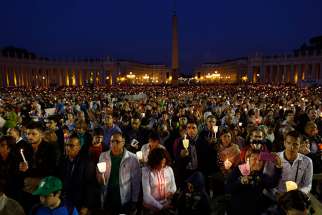 People attend an Oct. 4 prayer vigil led by Pope Francis for the extraordinary Synod of Bishops on the family in St. Peter&#039;s Square at the Vatican. The pope called for &quot;sincere, open and fraternal&quot; debate during the two-week long synod, which opened Oct. 5.