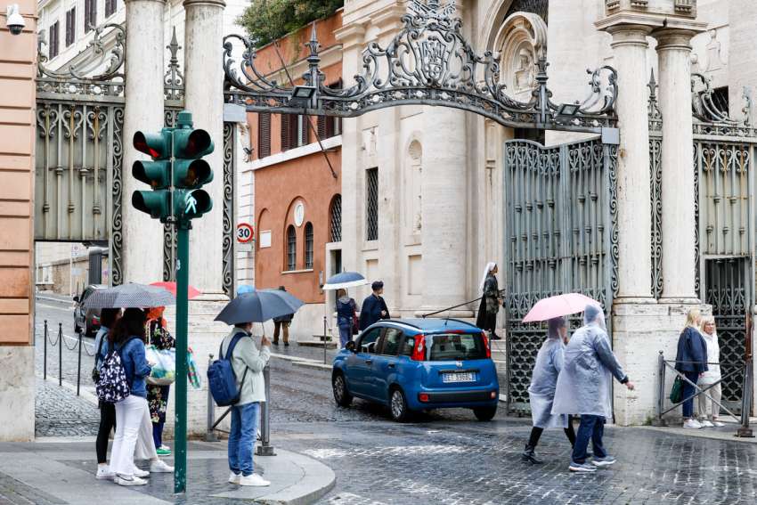 A car enters the Sant&#039;Anna entrance to Vatican City State guarded by Swiss Guards and Vatican gendarmes May 19, 2023. A man forcibly drove past security check points to enter the Vatican May 18 before he was arrested and placed in a Vatican detention cell.