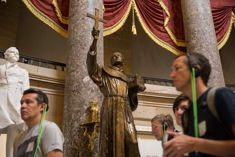 Tourists walk past a statue of Blessed Junipero Serra in Statuary Hall on Capitol Hill in Washington Sept. 21. Pope Francis celebrated a Mass of canonization for Blessed Junipero Serra Sept. 23 outside the Basilica of the National Shrine of the Immaculate Conception in Washington.