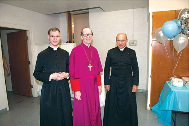Phoenix Bishop Thomas J. Olsted, centre, is seen with Frs. Kenneth Walker, left, and Joseph Terra, right, in a recent photo. On June 11 the priests were victims of a violent attack. Fr. Walker died of a gunshot wound while Terra is recovering from serious injuries.