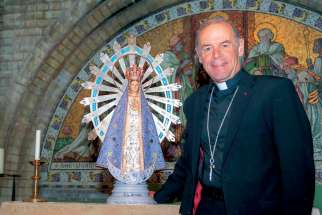 Bishop Paul Mason of the military diocese of England and Wales is pictured in an undated photo with a replica of Our Lady of Lujan, patroness of Argentina and the Argentine army. Mason has agreed to personally return the statue to Bishop Santiago Olivera of the Military Ordinariate of Argentina.