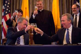 John Garvey, right, president of The Catholic University of America, toasts Greg Craven, vice chancellor of Australian Catholic University, in Washington Jan. 29 after they signed a memorandum of understanding for their universities&#039; new Rome Center.