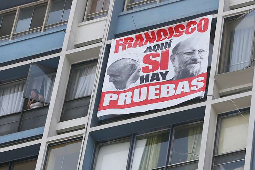 A protest banner that says in Spanish, &quot;Yes, Francis, here there is proof,&quot; hangs near the cathedral in Lima, Peru, Jan. 21. The banner protests Pope Francis&#039; defense of Bishop Juan Barros of Osorno, Chile, who is accused of protecting a priest the Vatican found guilty of sexual abuse of minors.