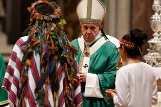 Pope Francis accepts offertory gifts from indigenous people as he celebrates the concluding Mass of the Synod of Bishops for the Amazon at the Vatican in this Oct. 27, 2019, file photo.