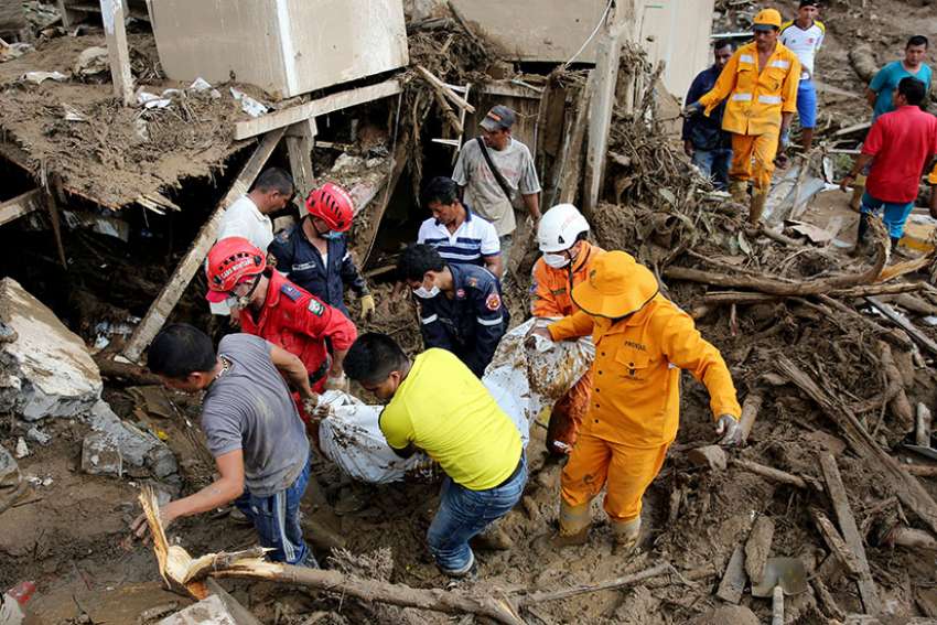 Rescue workers recover the body of mudslide victim April 2 in Mocoa, Colombia. Rescue crews searched for survivors after mudslides devastated areas of southern Colombia, killing more than 250 people.