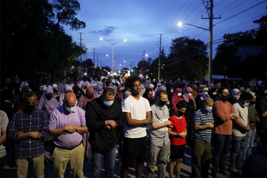 People attend a prayer vigil outside a mosque in London, Ontario, June 8, 2021, after four members of a Muslim family were killed.