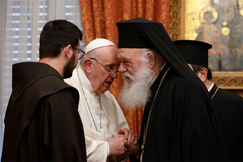 Pope Francis talks with Orthodox Archbishop Ieronymos II of Athens and all Greece during a meeting with their delegations in the Throne Room of the archbishopric in Athens, Greece, Dec. 4, 2021.