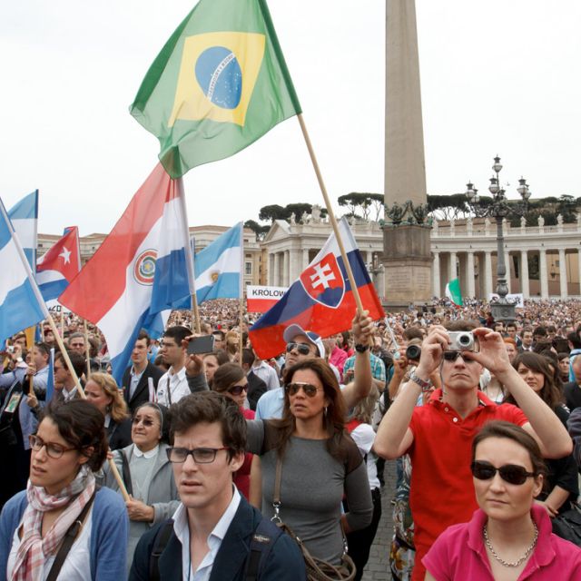 Young people in St. Peter&#039;s Square hold the national flags of Brazil and other countries as they attend Pope Benedict XVI&#039;s &quot;Regina Coeli&quot; prayed from the window of his apartment at the Vatican April 29.