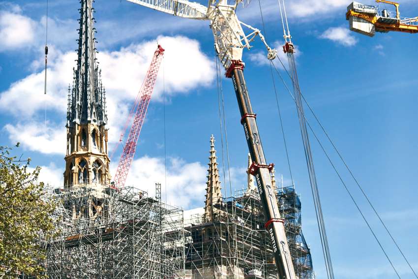 The spire of Notre Dame Cathedral, pictured April 10, is now back atop the iconic structure with part of the scaffolding removed.