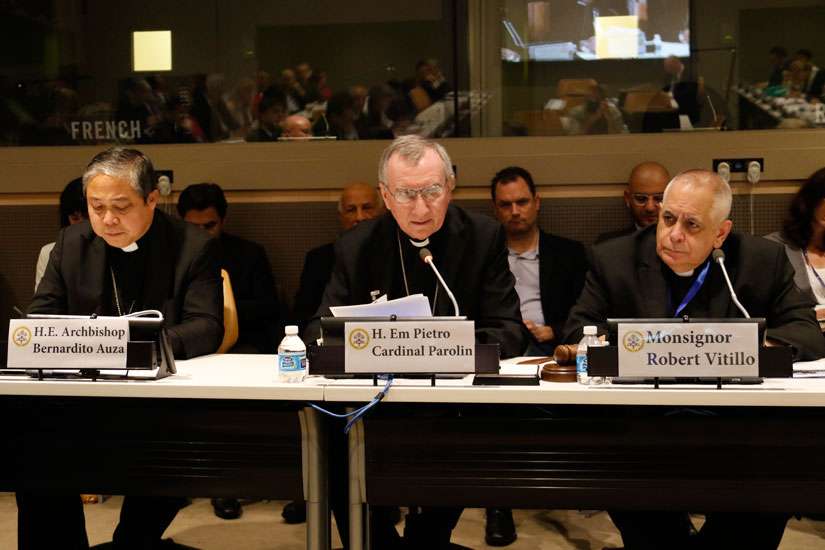 Cardinal Pietro Parolin, Vatican secretary of state, speaks during a high-level side event Sept. 19 at the United Nations on the role of religious organizations in responding to the ongoing refugee and migration crisis affecting many areas of the world. Also pictured are Archbishop Bernardito Auza, left, the Vatican&#039;s permanent observer to the U.N., and Msgr. Robert J. Vitillo, secretary-general of the International Catholic Migration Commission.