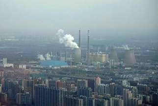 A thermal power plant is seen Nov. 21 near residential buildings in Beijing. As government delegations from across the globe prepare for a Dec. 2-14 U.N. conference on climate change, Catholic organizations are urging radical steps and pledging to make the church&#039;s voice heard.