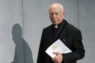 Cardinal Francesco Coccopalmerio, then-president of the Pontifical Council for Legislative Texts, arrives for a news conference at the Vatican in this Sept. 8, 2015, file photo.