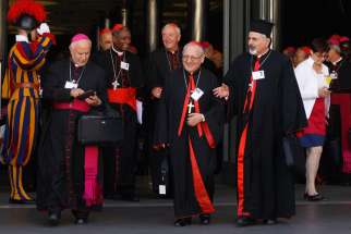 Archbishop Louis Sako of Baghdad, Iraq, patriarch of the Chaldean Catholic Church, center, and other prelates leave the opening session of the extraordinary Synod of Bishops on the family at the Vatican Oct. 6.