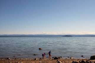 Children play on the shore of Frobisher Bay in Iqaluit, Nunavut, July 26, 2022. The French Ministry of Justice announced that France will not extradite Oblate Father Joannès Rivoire, 92, to face charges of abuse in Canada. The priest has denied the accusations.