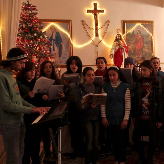 Iraqi refugees sing during Mass at a Chaldean Catholic church in Amman, Jordan, Dec. 22. Thousands of Iraqi Christians fled to neighboring Jordan following a spate of bombings that targeted churches in their country in the past few years.