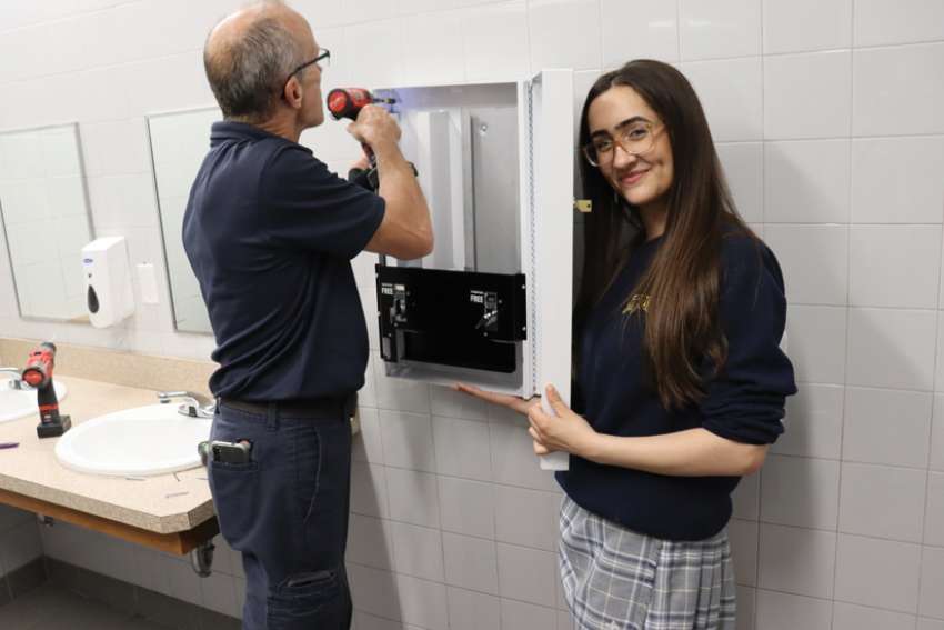 Jada Malott is all smiles as the first free menstrual product dispenser is installed at Windsor, Ont.’s St. Joseph’s Catholic High School.