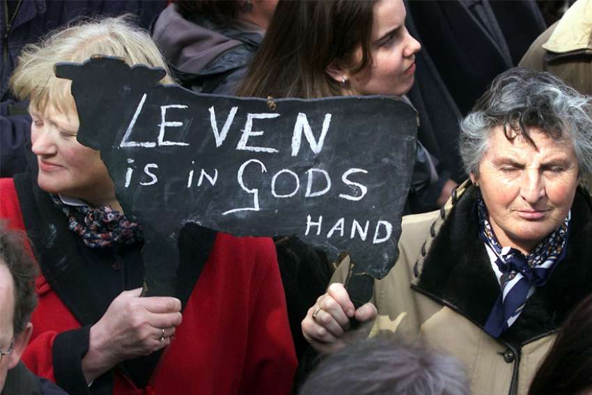 Women opposed to euthanasia are pictured in a file photo holding up a sign reading &quot;life is in God&#039;s hands&quot; during a silent demonstration in Den Bosch, Netherlands. Cardinal Willem Eijk of Utrecht, Netherlands, says the proposal to allow the euthanasia of children in the Netherlands would mark only the latest slide down the slippery slope of euthanasia.