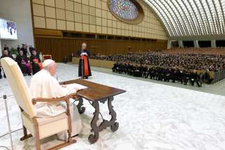 Pope Francis listens to Korean Cardinal Lazarus You Heung-sik, prefect of the Dicastery for Clergy, at the beginning of a meeting with hundreds of seminarians and priests studying in Rome, in the Vatican audience hall, Oct. 24, 2022.