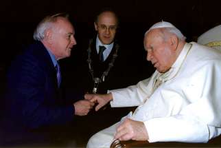 Dr. Robert Walley, left, founder of MaterCare International, meets Pope John Paul II.