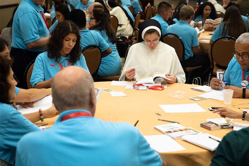 A woman religious is seen with delegates during a breakout session Sept. 21 at the Fifth National Encuentro in Grapevine, Texas.