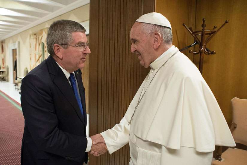 Thomas Bach, president of the International Olympic Committee, greets Pope Francis during their meeting ahead of the opening ceremony of first global conference of faith and sport at the Vatican City, Oct. 5.