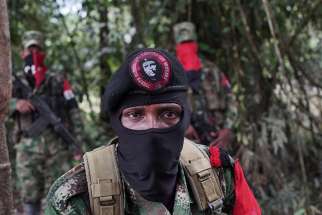 Yerson, the commander of the National Liberation Army, is photographed Aug. 30 in the northwestern jungles of Colombia.
