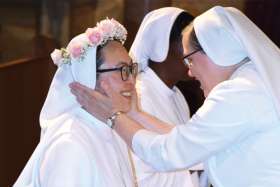 Sr. Hae-Jin Lim is embraced during her perpetual profession in August.