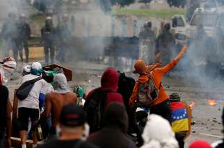 Demonstrators clash with riot security forces while rallying against Venezuela President Nicolas Maduro&#039;s government July 28 in Caracas. 