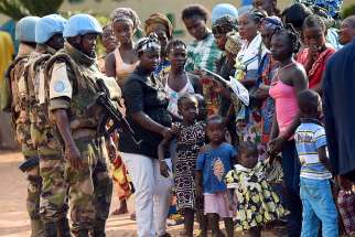 U.N. peacekeeping soldiers patrol alongside women and children in 2015 in Bangui, Central African Republic. 
